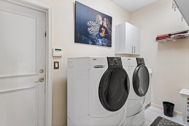 1345 SW 21st Ave, Boca Raton, FL 33486 - laundry area featuring separate washer and dryer, light tile patterned flooring, baseboards, and cabinet space
