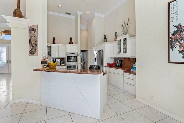 1345 SW 21st Ave, Boca Raton, FL 33486 - kitchen featuring dark countertops, light tile patterned flooring, ornamental molding, appliances with stainless steel finishes, and tasteful backsplash