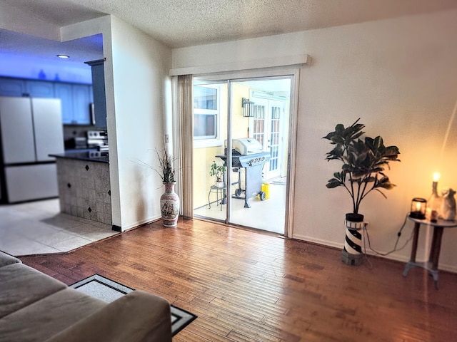1514 SE Manth Ln, Port Saint Lucie, FL 34983 - living room with hardwood / wood-style floors, a textured ceiling, and baseboards