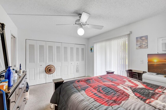 210 Chatham K, West Palm Beach, FL 33417 - carpeted bedroom featuring access to exterior, a ceiling fan, and a textured ceiling