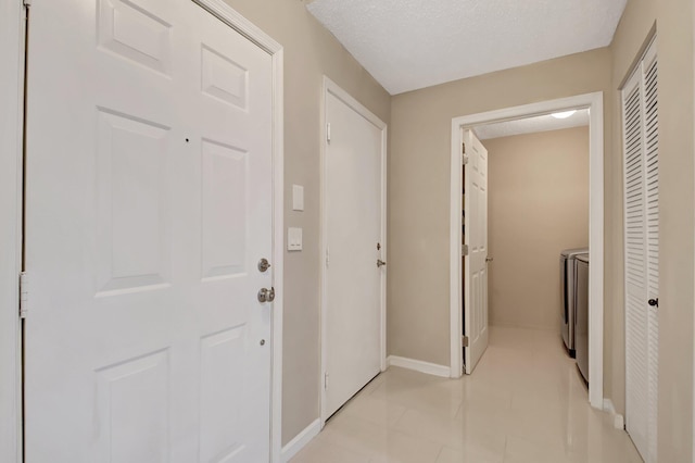9308 Swansea Ln, West Palm Beach, FL 33411 - hallway featuring washer and clothes dryer and baseboards