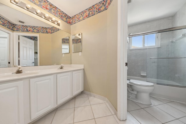 7969 Heavener Ct, Lake Worth, FL 33467 - bathroom with tile patterned flooring, double vanity, toilet, bath / shower combo with glass door, and baseboards