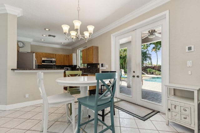 7969 Heavener Ct, Lake Worth, FL 33467 - dining room featuring french doors, a chandelier, crown molding, light tile patterned floors, and recessed lighting