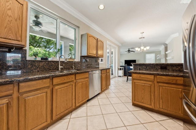 7969 Heavener Ct, Lake Worth, FL 33467 - kitchen featuring appliances with stainless steel finishes, a sink, decorative backsplash, ornamental molding, and brown cabinetry