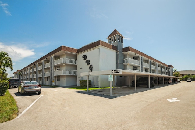 1040 SE 4th Ave Unit 129, Deerfield Beach, FL 33441 - view of apartment building / complex with covered and uncovered parking