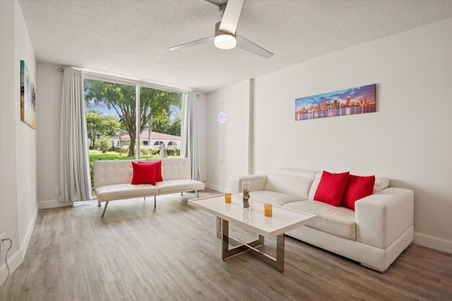1040 SE 4th Ave Unit 129, Deerfield Beach, FL 33441 - living area with wood finished floors, a textured ceiling, and ceiling fan