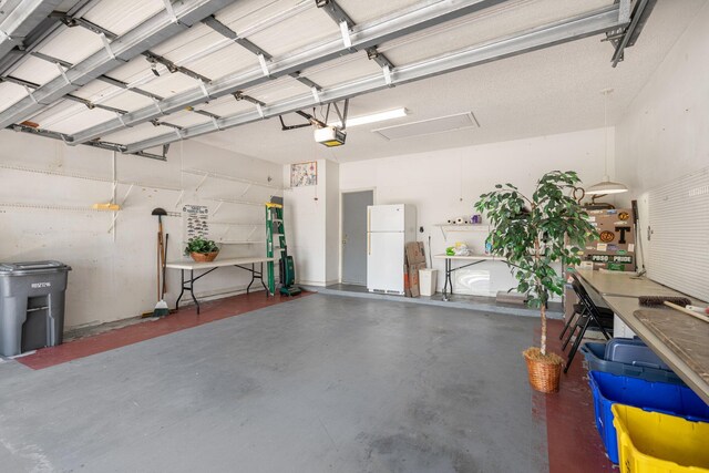 7585 Las Cruces Ct, Boynton Beach, FL 33437 - garage with freestanding refrigerator and a garage door opener