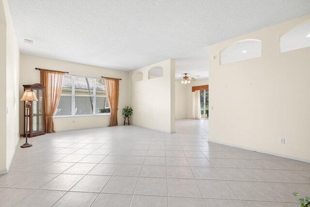 7585 Las Cruces Ct, Boynton Beach, FL 33437 - unfurnished room featuring light tile patterned floors, plenty of natural light, ceiling fan, and a textured ceiling