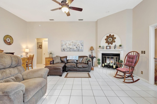 12697 Coral Breeze Dr, Wellington, FL 33414 - living room with ceiling fan, a fireplace, light tile patterned flooring, and baseboards