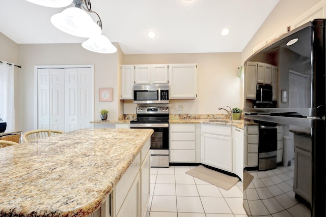 12697 Coral Breeze Dr, Wellington, FL 33414 - kitchen with stainless steel appliances, white cabinetry, light tile patterned flooring, light stone countertops, and hanging light fixtures