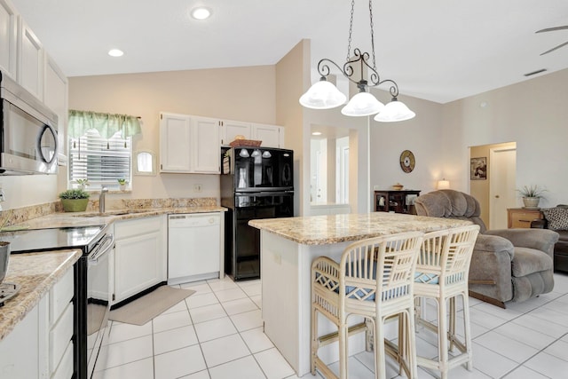 12697 Coral Breeze Dr, Wellington, FL 33414 - kitchen with dishwasher, freestanding refrigerator, stainless steel microwave, electric stove, and open floor plan