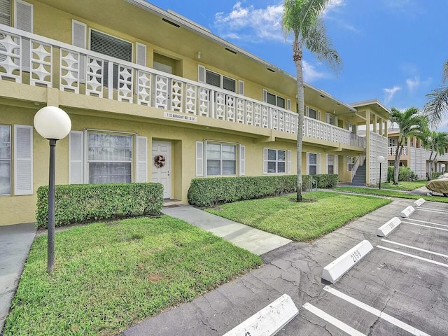 1120 Mahogany Way Unit 204, Delray Beach, FL 33445 - view of building exterior featuring uncovered parking
