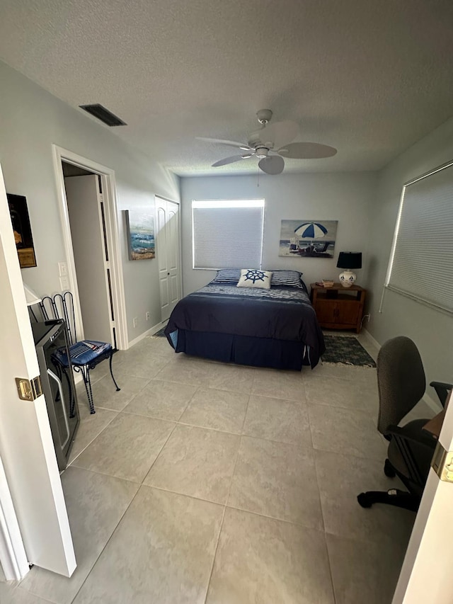 1120 Mahogany Way Unit 204, Delray Beach, FL 33445 - bedroom featuring light tile patterned flooring, a textured ceiling, and a ceiling fan