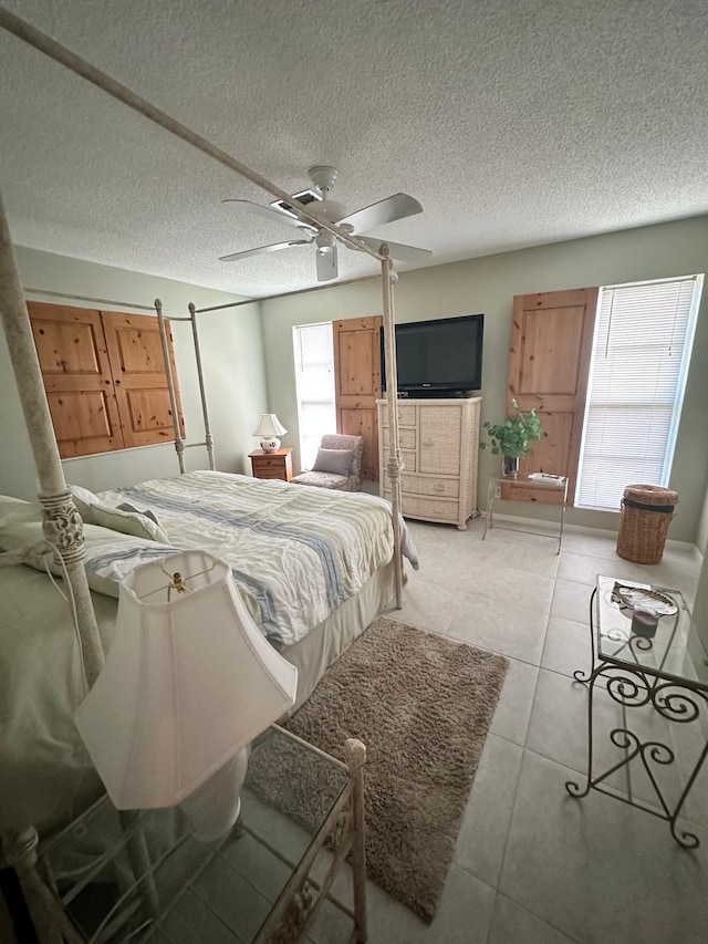 1120 Mahogany Way Unit 204, Delray Beach, FL 33445 - bedroom featuring a ceiling fan, light tile patterned floors, and a textured ceiling