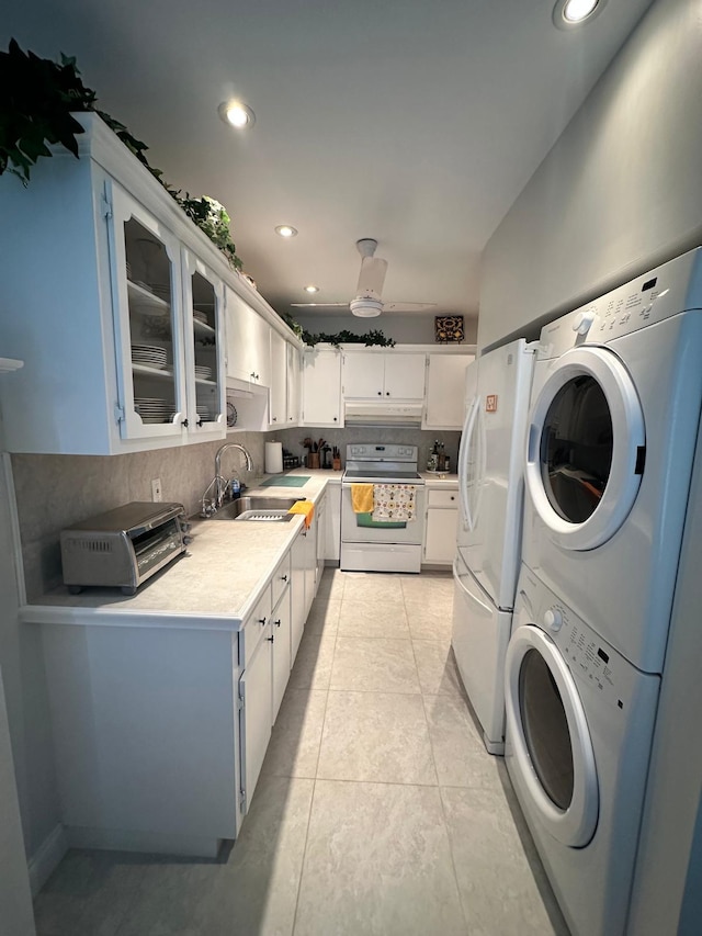 1120 Mahogany Way Unit 204, Delray Beach, FL 33445 - kitchen with white appliances, a sink, stacked washer / drying machine, under cabinet range hood, and light countertops