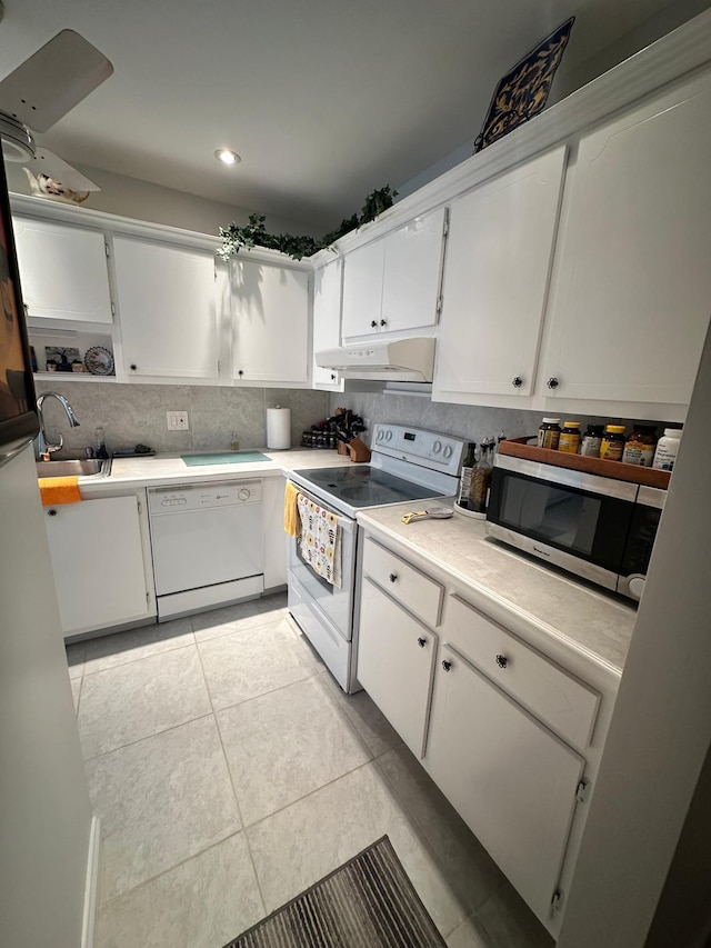 1120 Mahogany Way Unit 204, Delray Beach, FL 33445 - kitchen featuring white appliances, under cabinet range hood, white cabinets, light countertops, and light tile patterned flooring