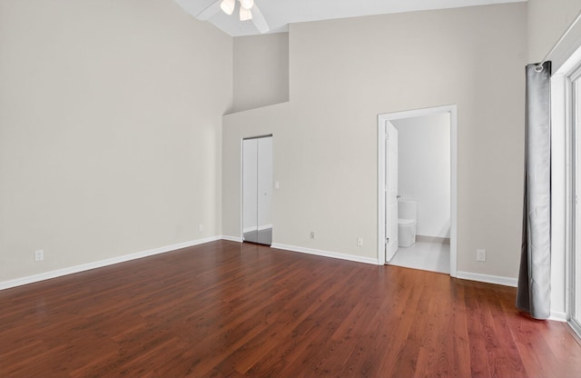 9329 Boca Gardens Cir S Unit D, Boca Raton, FL 33496 - unfurnished bedroom with dark wood finished floors, high vaulted ceiling, and ensuite bath
