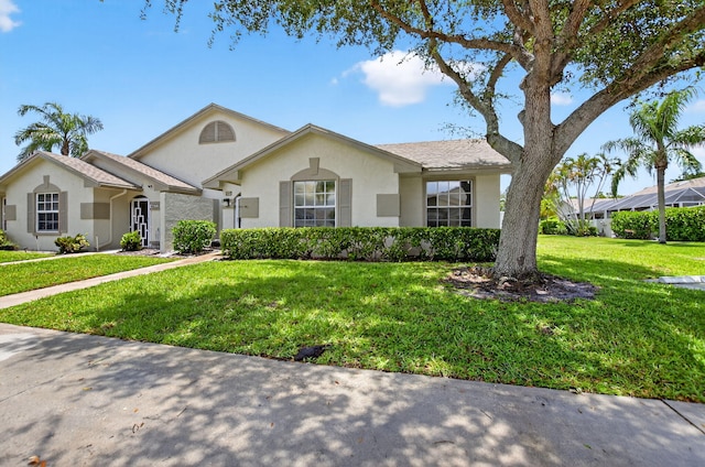 9329 Boca Gardens Cir S Unit D, Boca Raton, FL 33496 - ranch-style house with stucco siding and a front yard