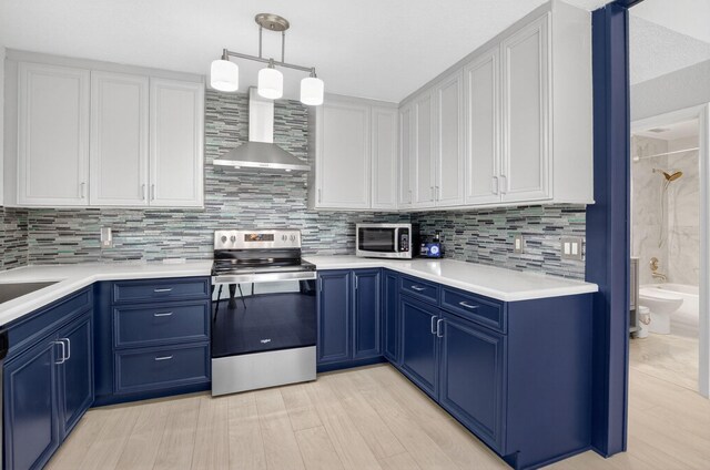 9329 Boca Gardens Cir S Unit D, Boca Raton, FL 33496 - kitchen with appliances with stainless steel finishes, wall chimney exhaust hood, blue cabinetry, white cabinets, and tasteful backsplash