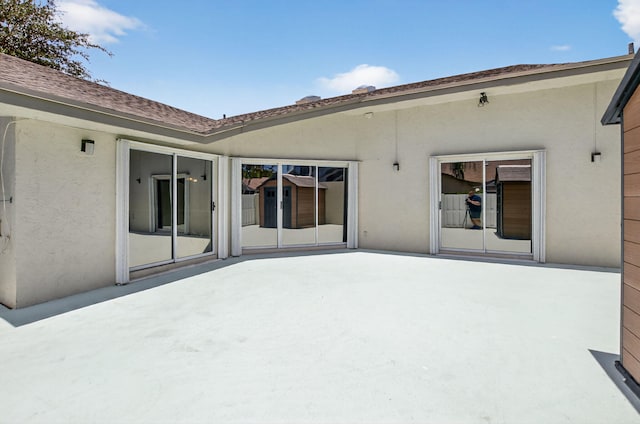 9329 Boca Gardens Cir S Unit D, Boca Raton, FL 33496 - back of property featuring stucco siding and a patio
