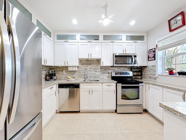 3622 Citrus Trce Unit 2, Davie, FL 33328 - kitchen featuring stainless steel appliances, a sink, backsplash, white cabinetry, and recessed lighting