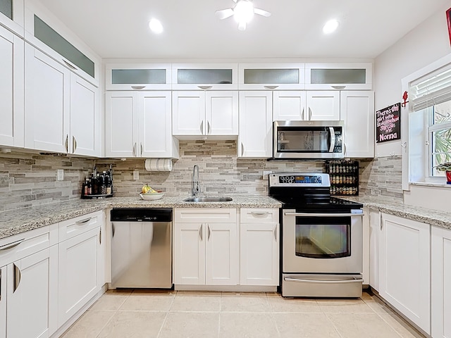 3622 Citrus Trce Unit 2, Davie, FL 33328 - kitchen with stainless steel appliances, a sink, backsplash, white cabinets, and recessed lighting