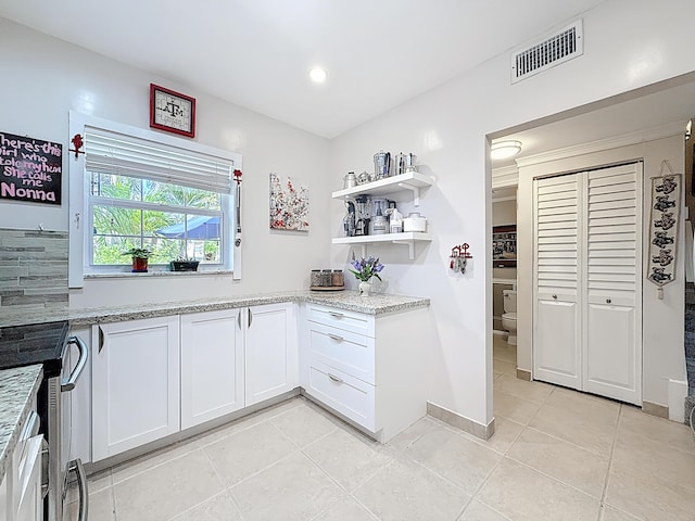 3622 Citrus Trce Unit 2, Davie, FL 33328 - kitchen with light tile patterned floors, open shelves, white cabinetry, light stone countertops, and recessed lighting