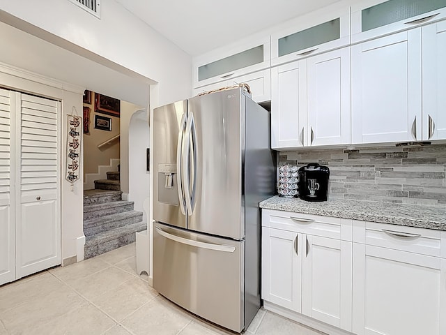 3622 Citrus Trce Unit 2, Davie, FL 33328 - kitchen with stainless steel fridge with ice dispenser, tasteful backsplash, light tile patterned floors, light stone countertops, and white cabinetry