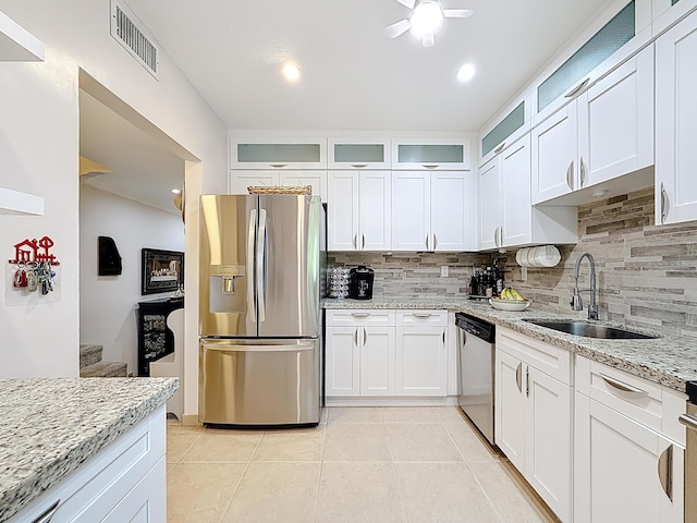 3622 Citrus Trce Unit 2, Davie, FL 33328 - kitchen with appliances with stainless steel finishes, a sink, decorative backsplash, and light tile patterned floors