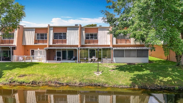 3622 Citrus Trce Unit 2, Davie, FL 33328 - back of house featuring a lawn, a balcony, a water view, and a sunroom