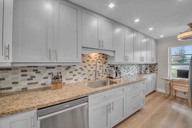 1140 Mahogany Way Unit 103, Delray Beach, FL 33445 - kitchen with dishwasher, a sink, light wood-style flooring, tasteful backsplash, and light stone countertops