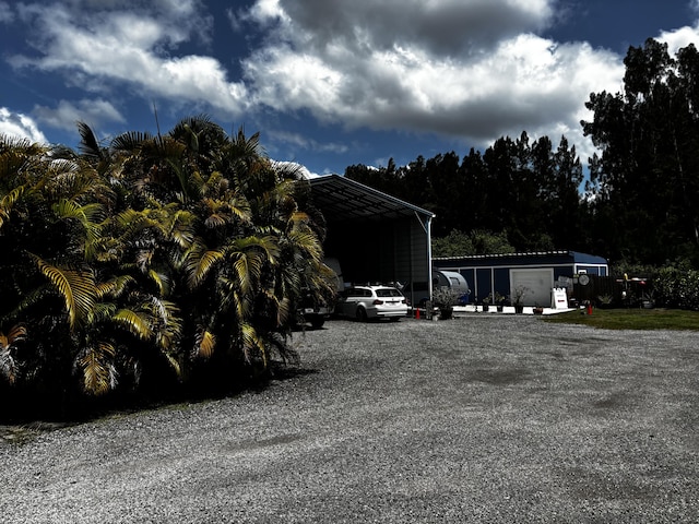 1210 Hartman Rd, Fort Pierce, FL 34947 - view of yard with driveway and a detached carport