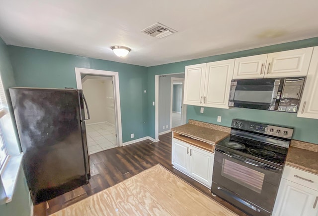 2818 Alabama St, West Palm Beach, FL 33406 - kitchen with black appliances, white cabinets, and dark wood-style flooring