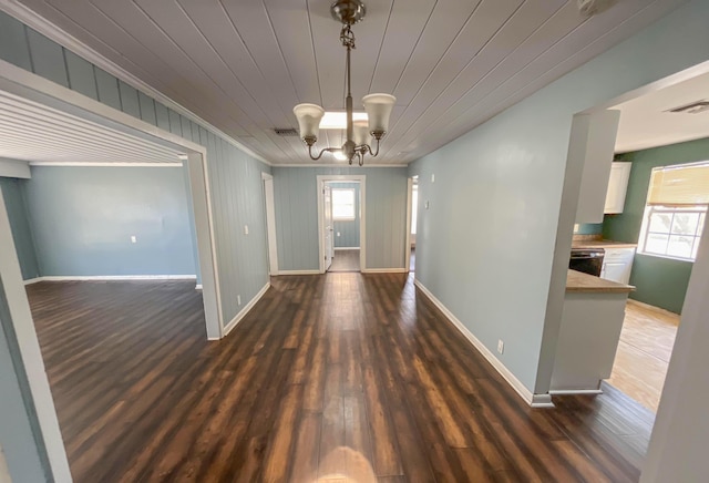 2818 Alabama St, West Palm Beach, FL 33406 - unfurnished dining area with ornamental molding, baseboards, wood finished floors, a chandelier, and wooden ceiling