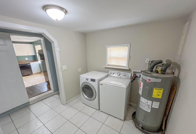 2818 Alabama St, West Palm Beach, FL 33406 - laundry area with water heater, light tile patterned floors, washing machine and clothes dryer, and arched walkways