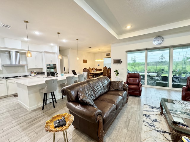 1130 Tangled Orchard Trce, The Acreage, FL 33470 - living area featuring light wood-style floors and recessed lighting