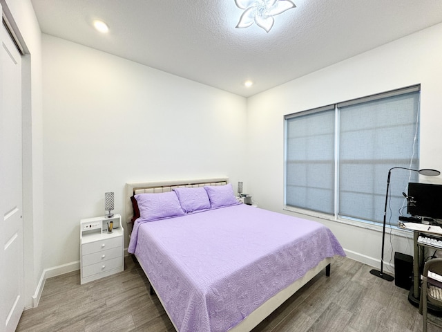 1130 Tangled Orchard Trce, The Acreage, FL 33470 - bedroom with wood finished floors, baseboards, and recessed lighting