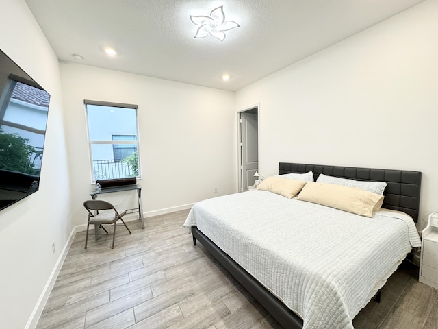 1130 Tangled Orchard Trce, The Acreage, FL 33470 - bedroom with light wood finished floors, baseboards, and recessed lighting
