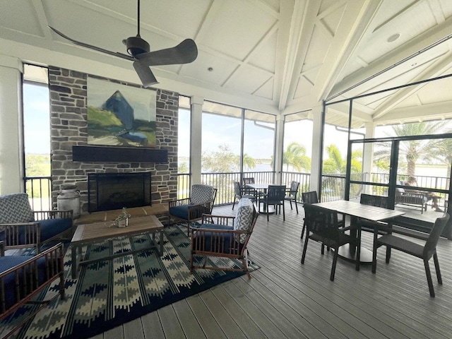 1130 Tangled Orchard Trce, The Acreage, FL 33470 - sunroom featuring outdoor dining space, ceiling fan, an outdoor living space with a fireplace, and a water view
