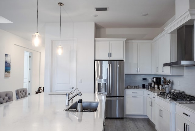 1130 Tangled Orchard Trce, The Acreage, FL 33470 - kitchen featuring stainless steel appliances, a sink, white cabinetry, backsplash, and wall chimney range hood