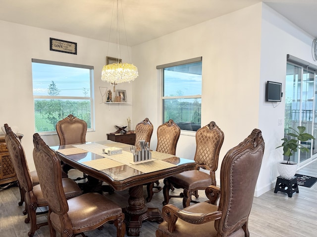 1130 Tangled Orchard Trce, The Acreage, FL 33470 - dining space featuring wood finished floors, a chandelier, and baseboards