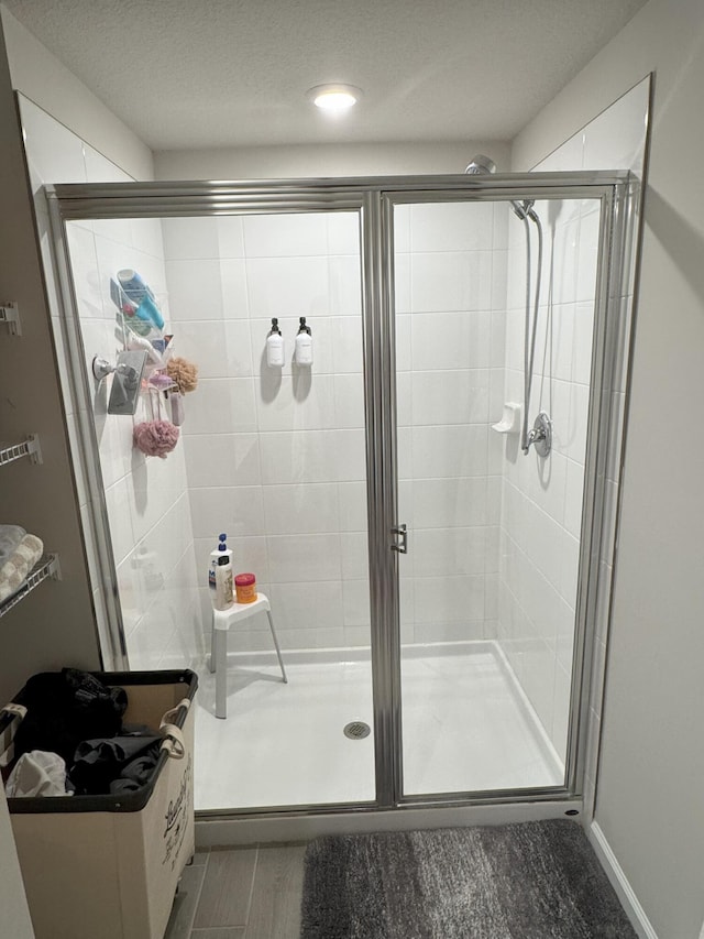 5700 Mentmore Dr, Mangonia Park, FL 33407 - bathroom with a stall shower and wood finished floors