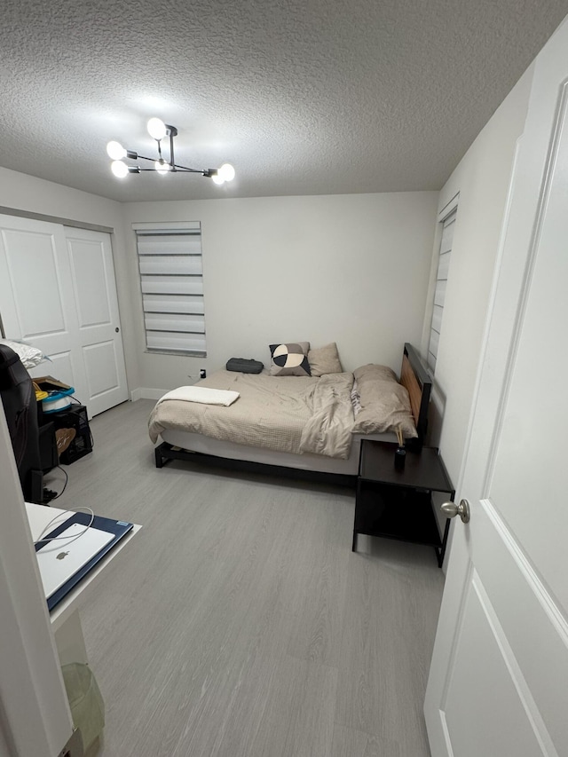 5700 Mentmore Dr, Mangonia Park, FL 33407 - bedroom with wood finished floors and a textured ceiling