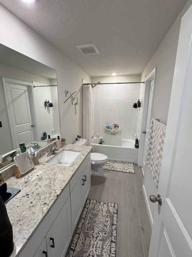 5700 Mentmore Dr, Mangonia Park, FL 33407 - bathroom featuring toilet, shower / bathtub combination with curtain, vanity, a textured ceiling, and wood tiled floors