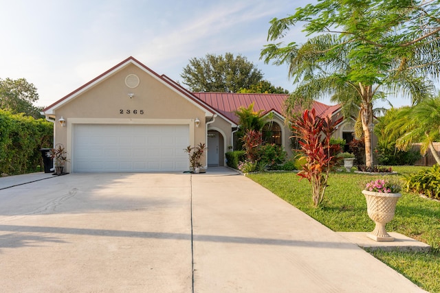 2365 SE Luau Ave, Port Saint Lucie, FL 34952 - view of front facade featuring concrete driveway, an attached garage, stucco siding, a front lawn, and metal roof