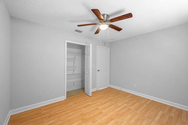 545 SW Buswell Ave, Port Saint Lucie, FL 34983 - unfurnished bedroom with light wood-style floors, baseboards, a closet, and a textured ceiling