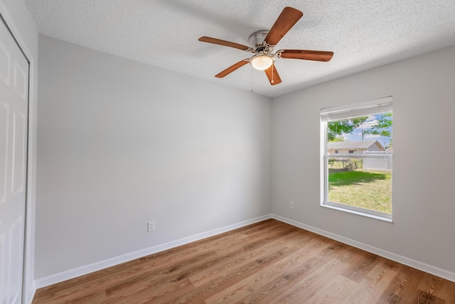 545 SW Buswell Ave, Port Saint Lucie, FL 34983 - spare room with light wood finished floors, baseboards, a textured ceiling, and ceiling fan