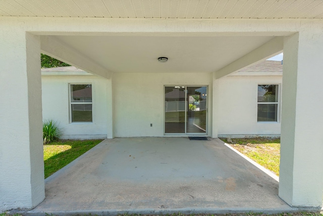 545 SW Buswell Ave, Port Saint Lucie, FL 34983 - property entrance featuring a patio and stucco siding