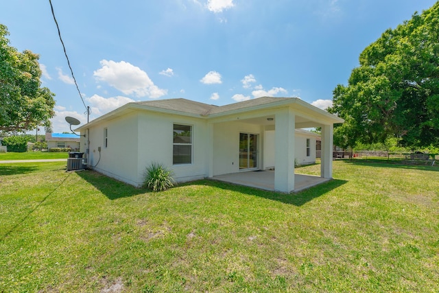 545 SW Buswell Ave, Port Saint Lucie, FL 34983 - back of property featuring a patio area, stucco siding, and central AC unit