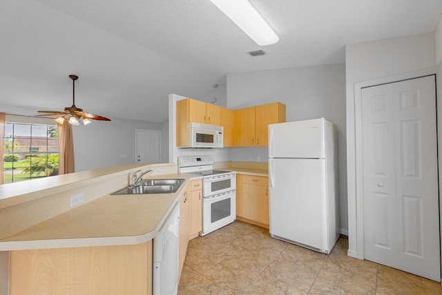 545 SW Buswell Ave, Port Saint Lucie, FL 34983 - kitchen featuring white appliances, a sink, light brown cabinets, a peninsula, and lofted ceiling